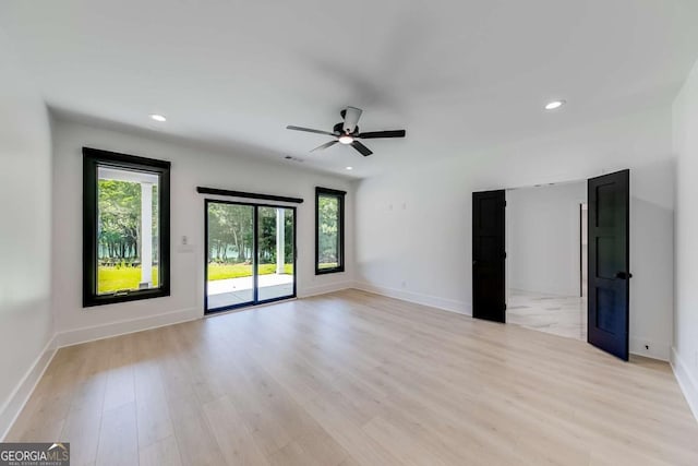 unfurnished room featuring ceiling fan and light hardwood / wood-style flooring