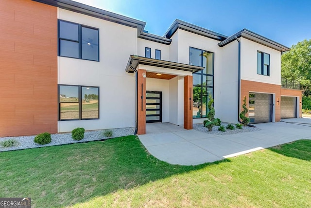 modern home with a garage and a front yard