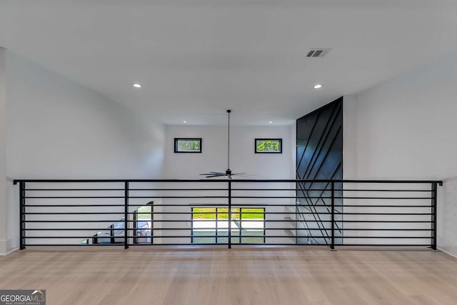 hall with a wealth of natural light and light wood-type flooring