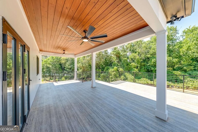 wooden deck featuring ceiling fan