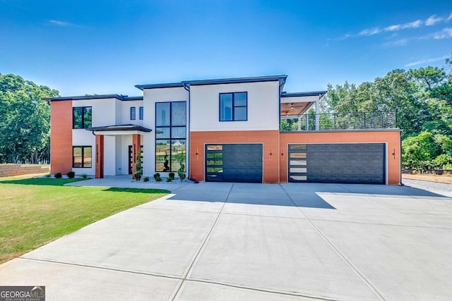 contemporary house featuring a garage and a front lawn