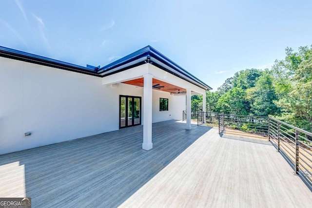 wooden deck featuring ceiling fan