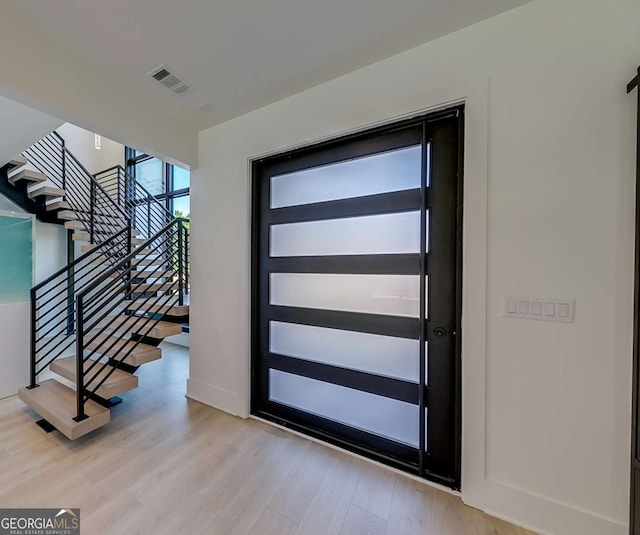 foyer with light hardwood / wood-style floors