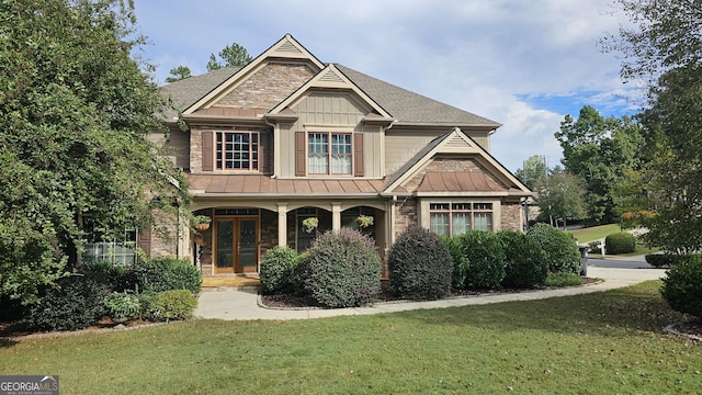 craftsman-style home featuring a front yard and covered porch