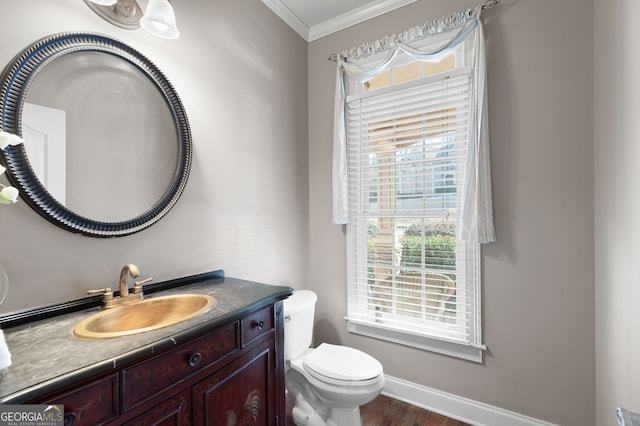 bathroom featuring vanity, hardwood / wood-style floors, crown molding, and toilet