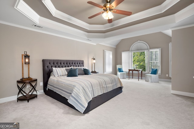 bedroom with ceiling fan, ornamental molding, carpet flooring, and a raised ceiling