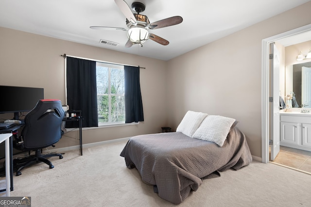 carpeted bedroom with connected bathroom and ceiling fan