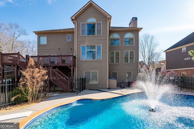 back of house featuring a wooden deck