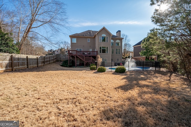 back of property featuring a pool side deck