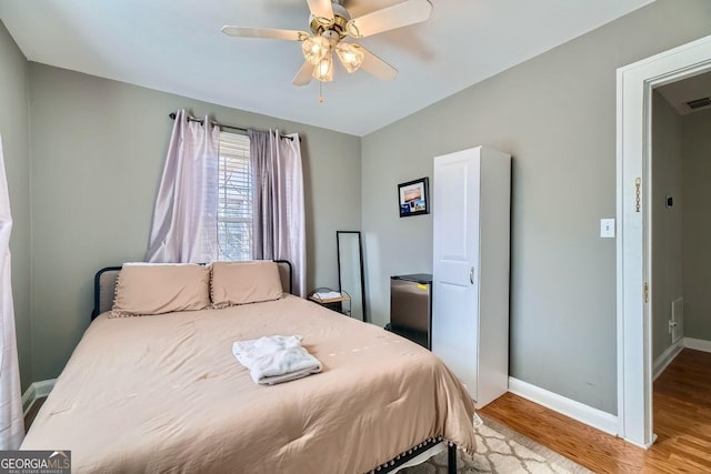 bedroom with ceiling fan and light hardwood / wood-style flooring