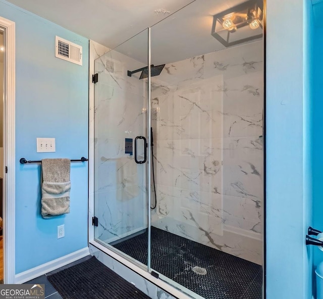 bathroom with tile patterned floors and a shower with door