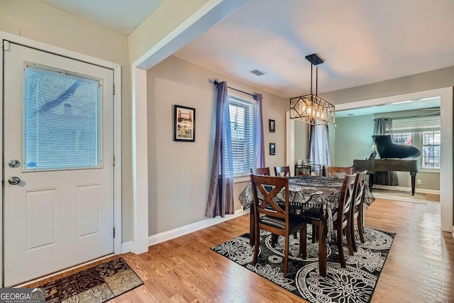 dining room featuring light hardwood / wood-style flooring and a notable chandelier