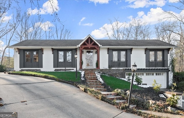 view of front facade featuring french doors and a garage