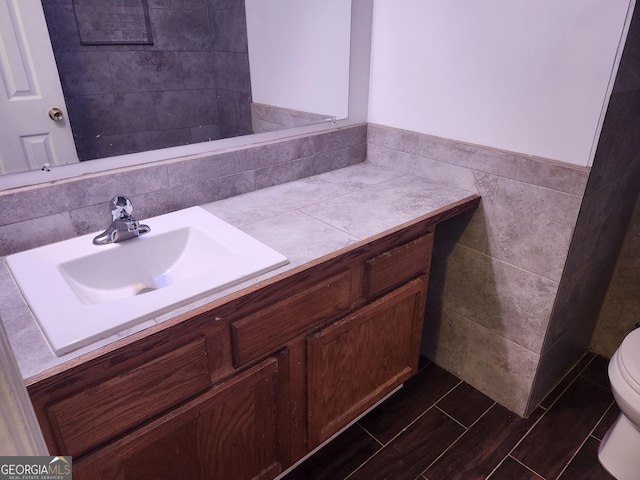 bathroom featuring toilet and vanity