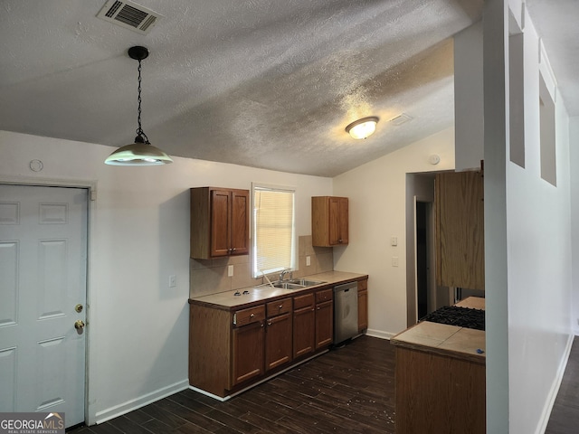 kitchen with backsplash, dark hardwood / wood-style flooring, pendant lighting, stainless steel dishwasher, and sink