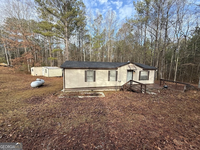 view of front of house with an outbuilding and a storage unit