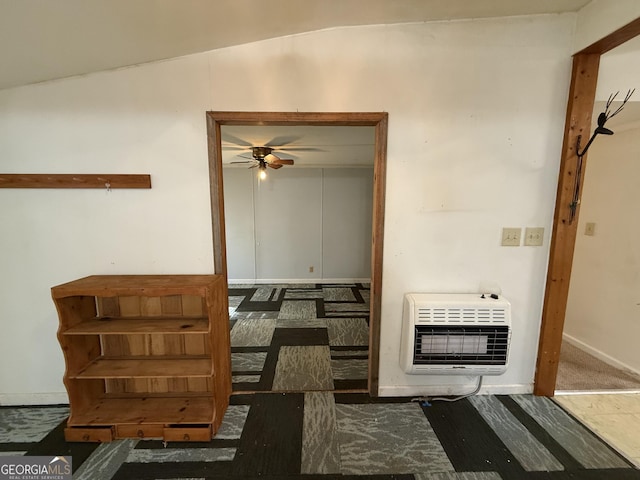 hallway featuring baseboards and heating unit