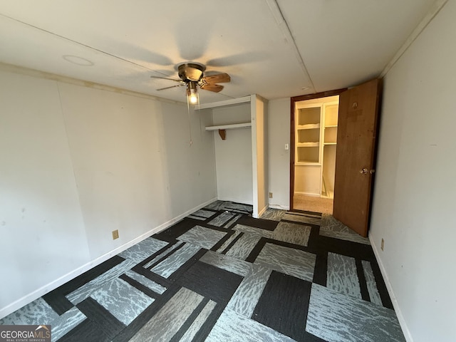 unfurnished bedroom featuring ceiling fan, a closet, and baseboards