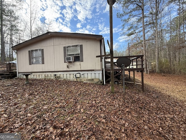 view of home's exterior featuring cooling unit, crawl space, and a wooden deck