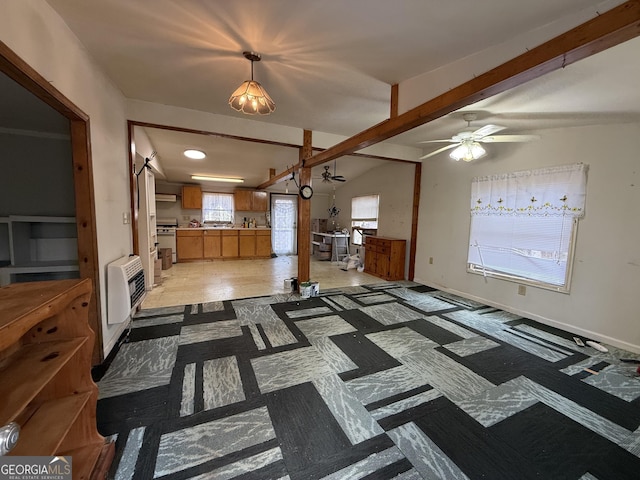 living room with ceiling fan, vaulted ceiling with beams, heating unit, and baseboards