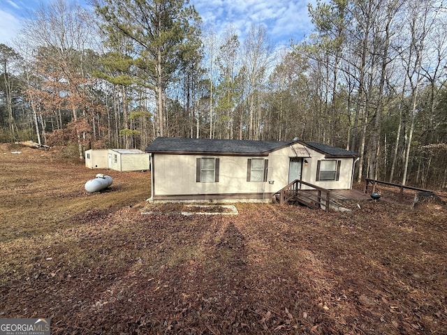 view of front of home featuring an outdoor structure and a storage unit