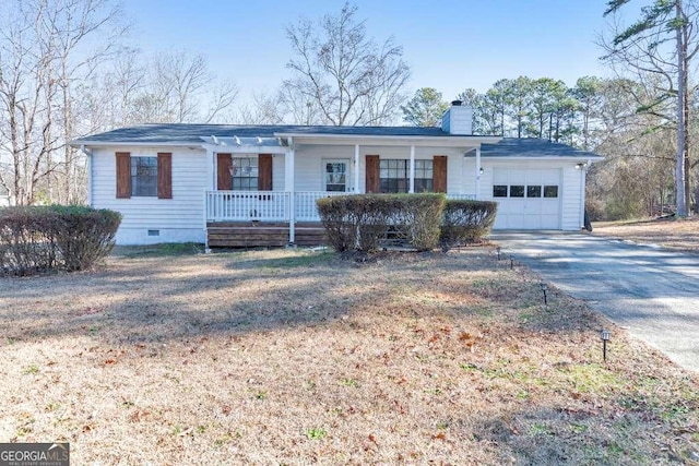 ranch-style house with covered porch and a garage