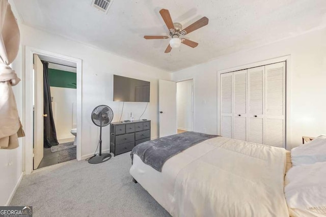 carpeted bedroom with ceiling fan, connected bathroom, and a closet