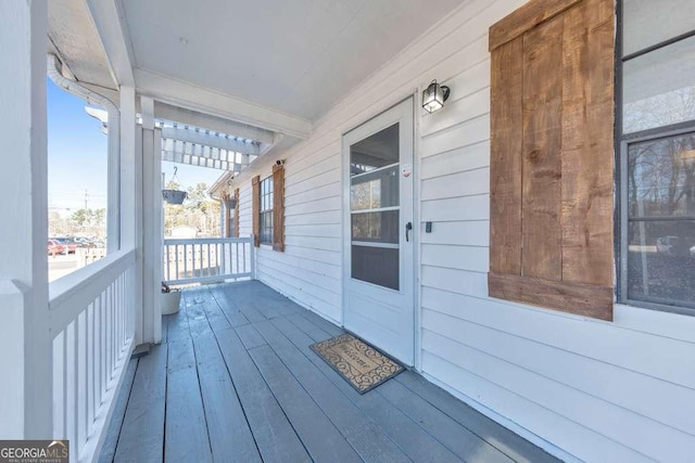 wooden terrace featuring covered porch