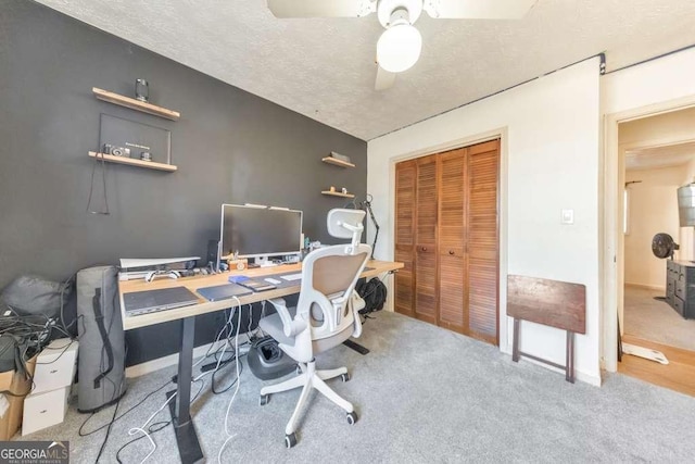 home office with ceiling fan, light colored carpet, and a textured ceiling