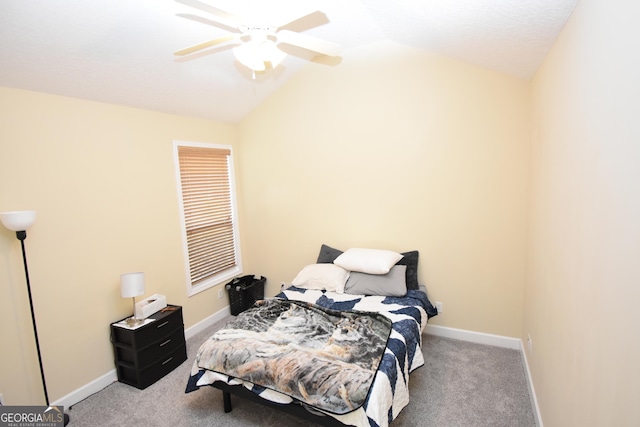 carpeted bedroom with ceiling fan and vaulted ceiling