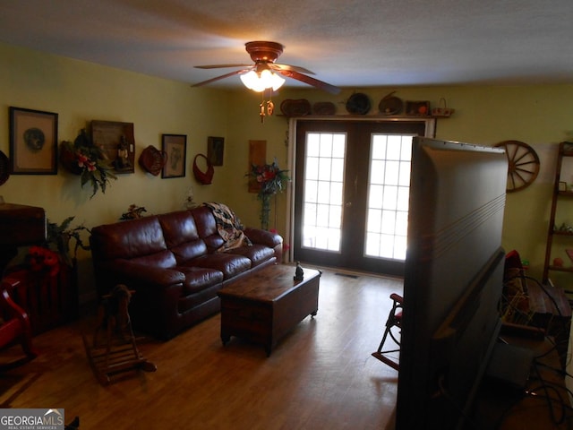 living room with ceiling fan, a healthy amount of sunlight, and wood-type flooring