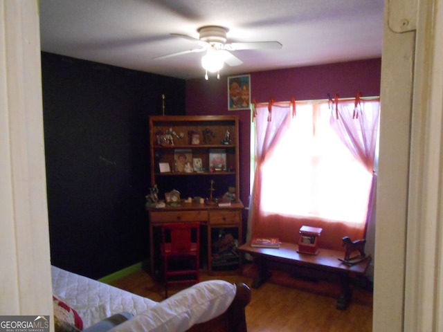 interior space with ceiling fan and hardwood / wood-style floors