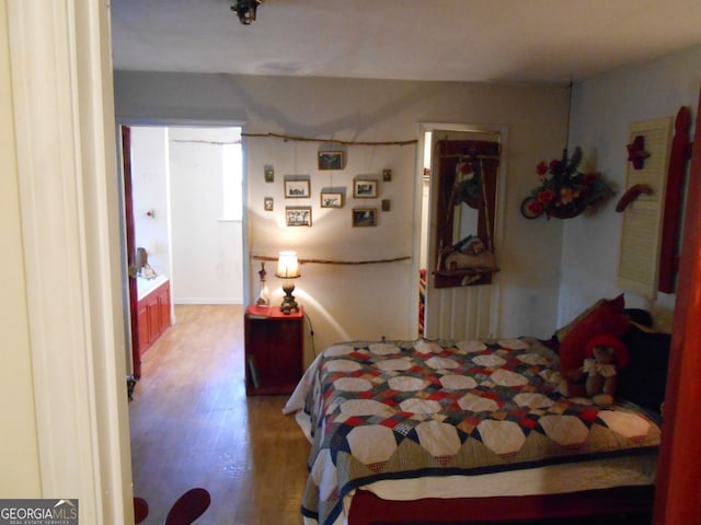 bedroom with hardwood / wood-style floors