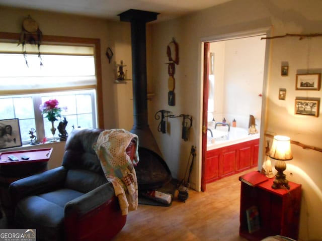 living room with light wood-type flooring and a wood stove