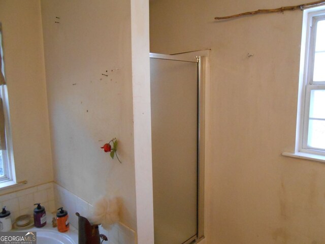 bathroom with a shower with shower door