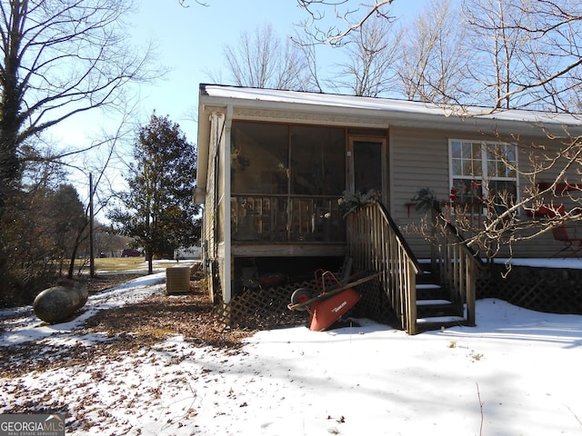 exterior space with cooling unit and a sunroom