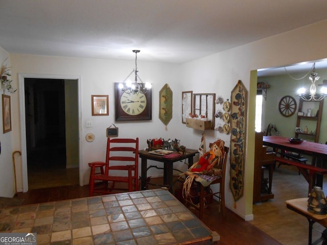 dining space featuring dark wood-type flooring and a chandelier