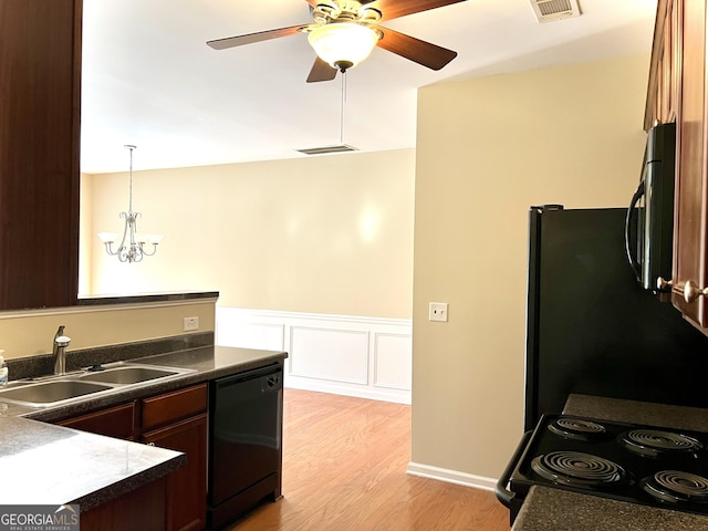 kitchen featuring ceiling fan with notable chandelier, dark brown cabinetry, black appliances, light hardwood / wood-style floors, and sink