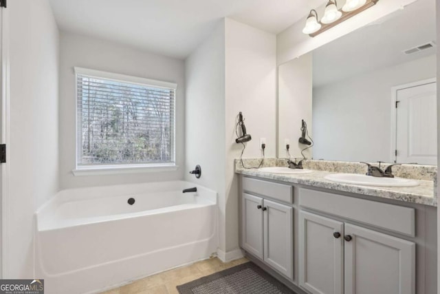 bathroom featuring vanity and a tub