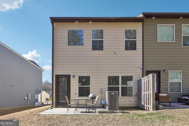 rear view of property with central AC and a patio area