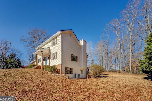 view of home's exterior with a chimney