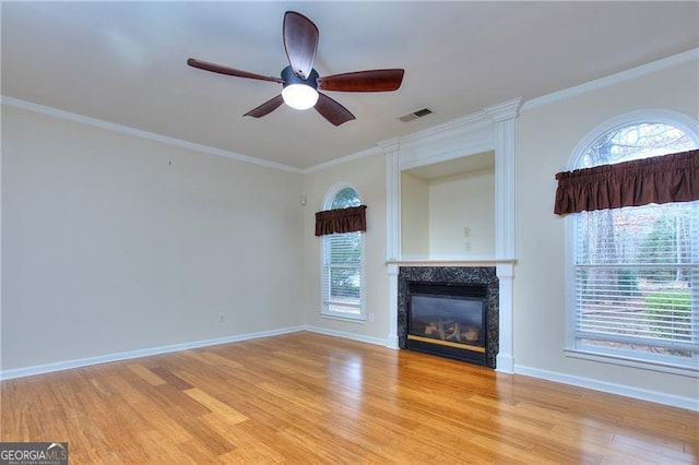 unfurnished living room featuring crown molding, ceiling fan, and light hardwood / wood-style floors