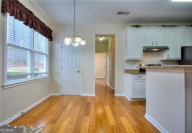 kitchen featuring decorative backsplash, decorative light fixtures, light hardwood / wood-style flooring, and white cabinets