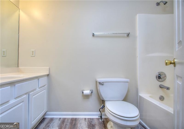 full bathroom with shower / tub combination, vanity, wood-type flooring, and toilet