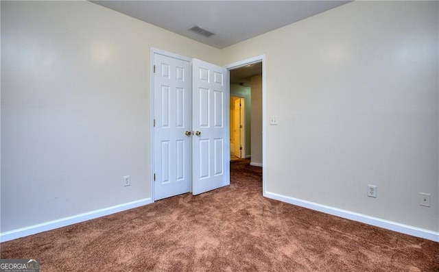 unfurnished bedroom with carpet and a closet