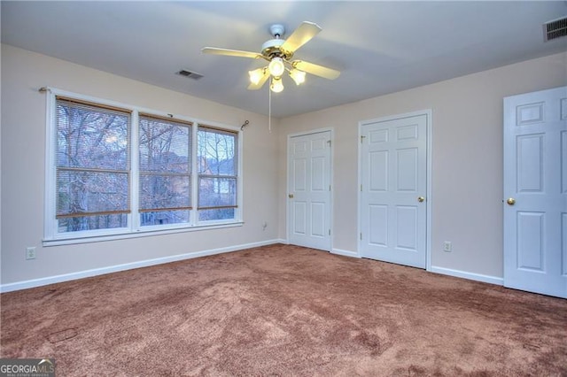 unfurnished bedroom with ceiling fan and carpet flooring