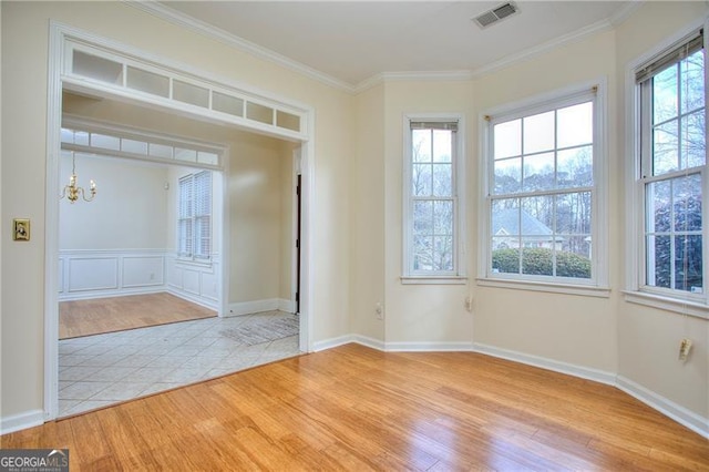 entrance foyer featuring crown molding, a chandelier, and light wood-type flooring