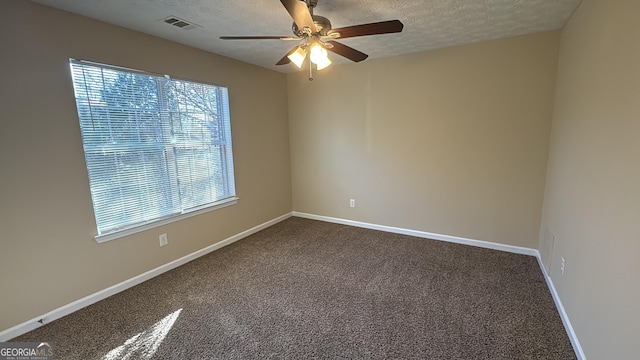 empty room featuring a textured ceiling, ceiling fan, and carpet floors