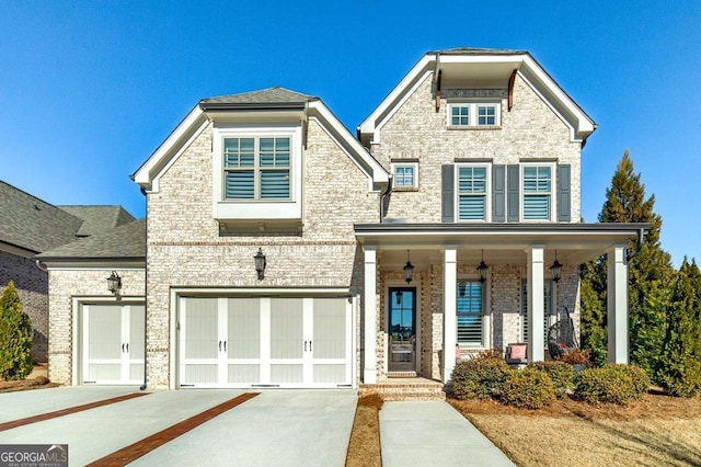 view of front of home featuring covered porch and a garage