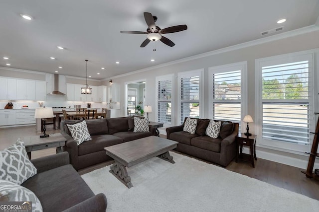 living room featuring ceiling fan, crown molding, and hardwood / wood-style flooring